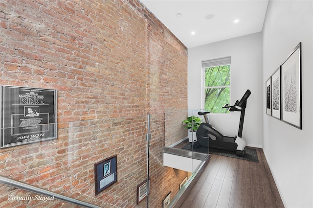 459 Vanderbilt Ave, Brooklyn, NY 11238 - exercise room with baseboards, wood finished floors, recessed lighting, and brick wall