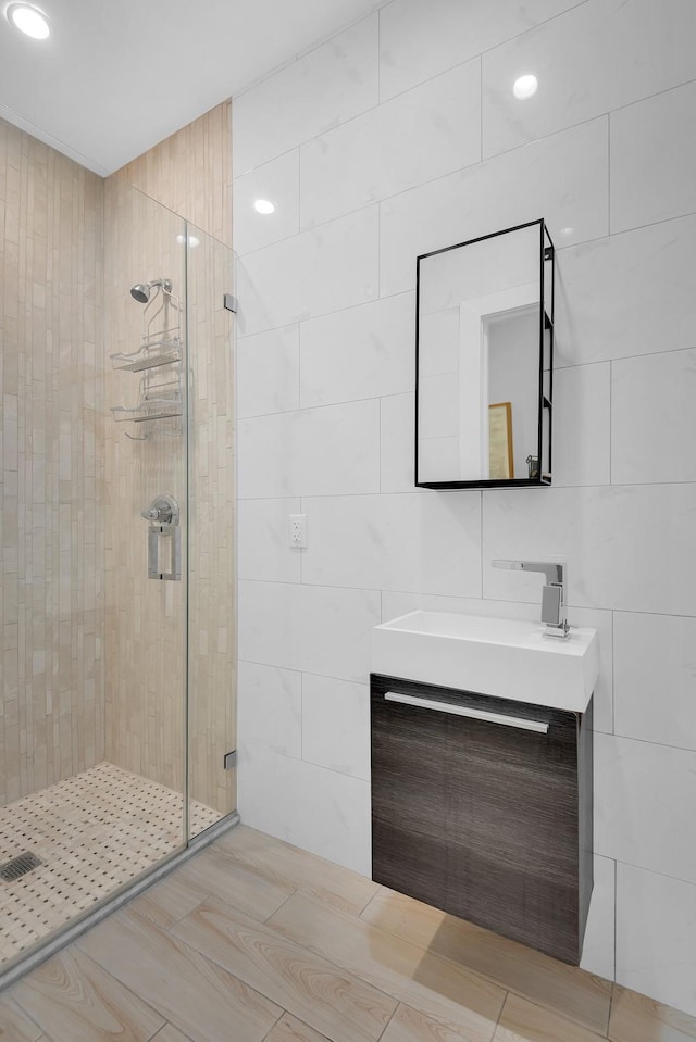 459 Vanderbilt Ave, Brooklyn, NY 11238 - bathroom with tile walls, a stall shower, vanity, and recessed lighting