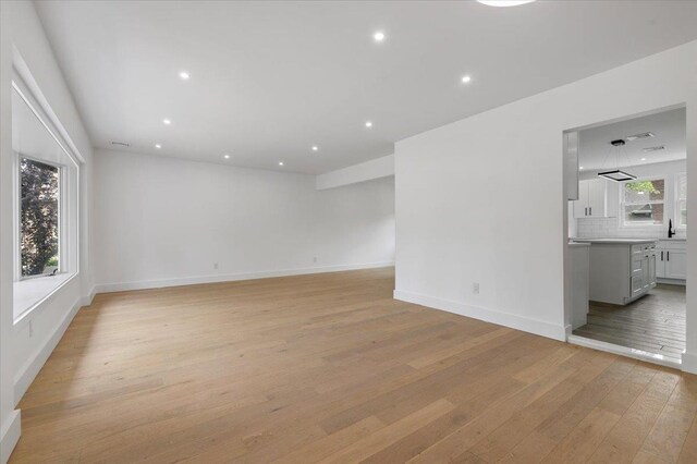 559 Linda Ln, Woodmere, NY 11598 - unfurnished room featuring light wood-style flooring, baseboards, a sink, and recessed lighting