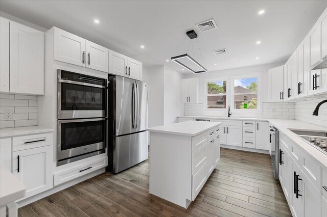 559 Linda Ln, Woodmere, NY 11598 - kitchen with stainless steel appliances, a sink, tasteful backsplash, recessed lighting, and white cabinets