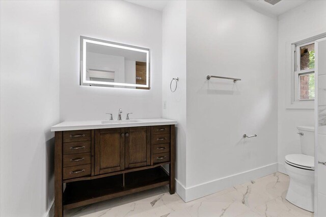 559 Linda Ln, Woodmere, NY 11598 - bathroom with marble look tile flooring, vanity, toilet, and baseboards