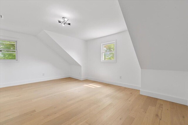 559 Linda Ln, Woodmere, NY 11598 - additional living space featuring light wood-style floors, baseboards, and vaulted ceiling
