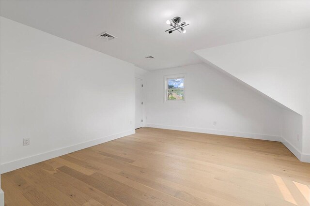 559 Linda Ln, Woodmere, NY 11598 - bonus room with light wood-type flooring, vaulted ceiling, and baseboards