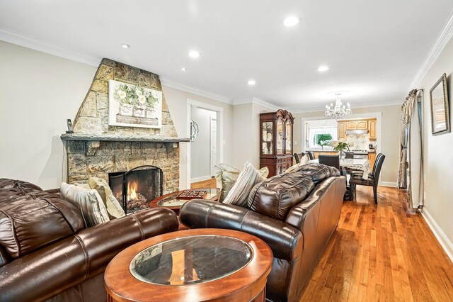 114 Longview Ave, White Plains, NY 10605 - living room featuring a chandelier, light wood-style floors, recessed lighting, crown molding, and a fireplace