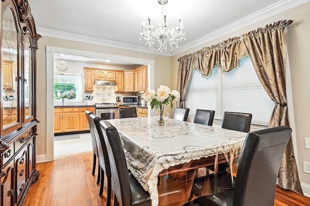 114 Longview Ave, White Plains, NY 10605 - dining area featuring a chandelier, light wood-type flooring, ornamental molding, and baseboards