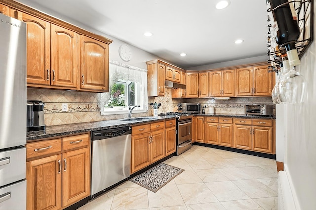 114 Longview Ave, White Plains, NY 10605 - kitchen with appliances with stainless steel finishes, a sink, under cabinet range hood, brown cabinets, and recessed lighting