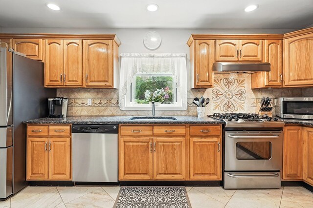 114 Longview Ave, White Plains, NY 10605 - kitchen with stainless steel appliances, a sink, under cabinet range hood, dark stone countertops, and recessed lighting