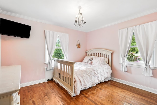 114 Longview Ave, White Plains, NY 10605 - bedroom with a chandelier, light wood-style flooring, baseboards, radiator heating unit, and ornamental molding