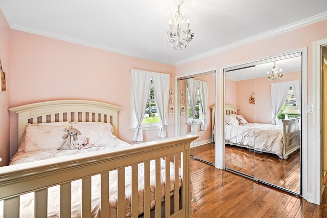 114 Longview Ave, White Plains, NY 10605 - bedroom featuring a chandelier, two closets, wood-type flooring, ornamental molding, and baseboards