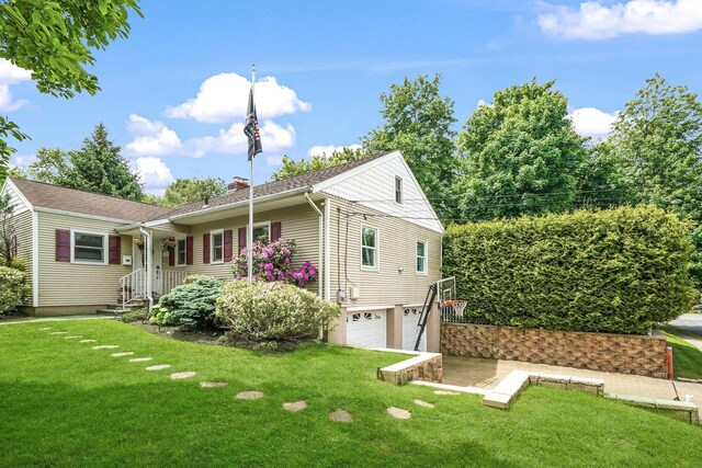 114 Longview Ave, White Plains, NY 10605 - view of front of house with an attached garage, a chimney, and a front lawn