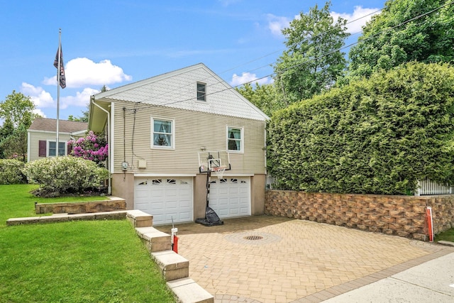 114 Longview Ave, White Plains, NY 10605 - view of front facade featuring an attached garage, decorative driveway, stucco siding, and a front lawn
