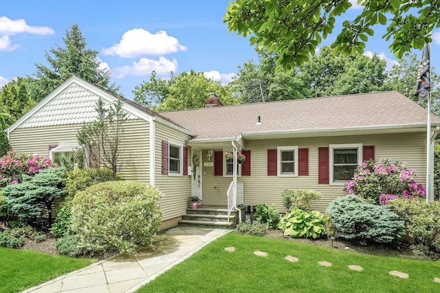 114 Longview Ave, White Plains, NY 10605 - view of front of home with a front lawn, a chimney, and roof with shingles