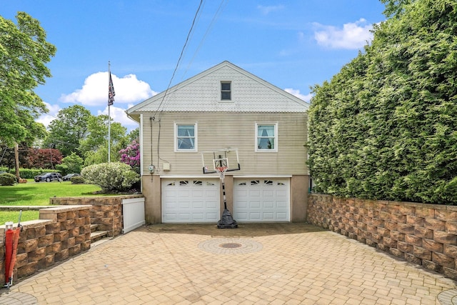 114 Longview Ave, White Plains, NY 10605 - view of property exterior with an attached garage, decorative driveway, and stucco siding