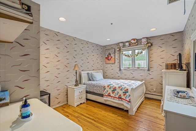 48 Fairfield Dr, Dix Hills, NY 11746 - bedroom with baseboard heating, light wood finished floors, and recessed lighting