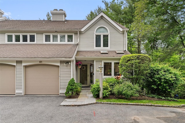 41 Boulder Ridge Rd, Scarsdale, NY 10583 - view of front of house with a chimney, driveway, and roof with shingles