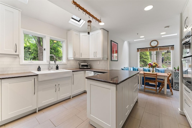 41 Boulder Ridge Rd, Scarsdale, NY 10583 - kitchen with decorative backsplash, white cabinetry, dark stone counters, and recessed lighting