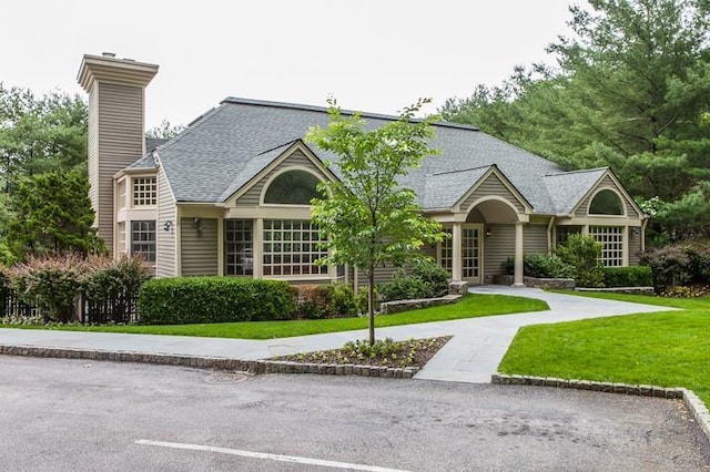 41 Boulder Ridge Rd, Scarsdale, NY 10583 - view of front of house with a chimney, a front yard, and a shingled roof