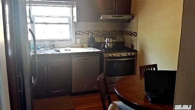 569 Peninsula Blvd, Cedarhurst, NY 11516 - kitchen featuring ventilation hood, stainless steel gas range, and decorative backsplash