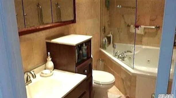 569 Peninsula Blvd, Cedarhurst, NY 11516 - full bathroom with toilet, bathing tub / shower combination, and vanity