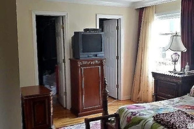 569 Peninsula Blvd, Cedarhurst, NY 11516 - bedroom featuring light wood-style floors and ornamental molding