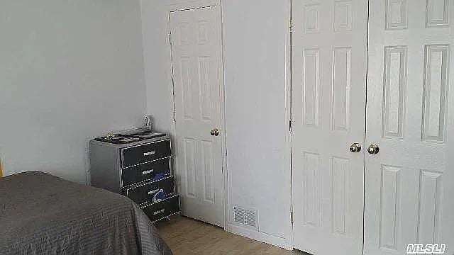 569 Peninsula Blvd, Cedarhurst, NY 11516 - bedroom with wood finished floors