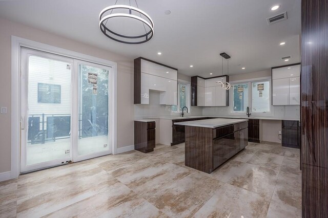 15 Old Nyack Tpke Unit 201, Monsey, NY 10952 - kitchen featuring modern cabinets, white cabinetry, a center island, a sink, and plenty of natural light