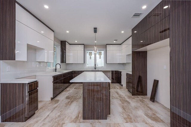 15 Old Nyack Tpke Unit 201, Monsey, NY 10952 - kitchen featuring modern cabinets, white cabinetry, a sink, a center island, and pendant lighting