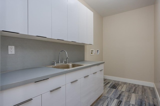15 Old Nyack Tpke Unit 201, Monsey, NY 10952 - kitchen with a sink, light countertops, white cabinetry, baseboards, and wood finished floors