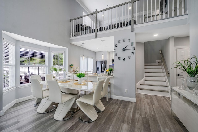 4 Cari Ln, Middle Island, NY 11953 - dining area with baseboards, wood finished floors, stairway, and a towering ceiling