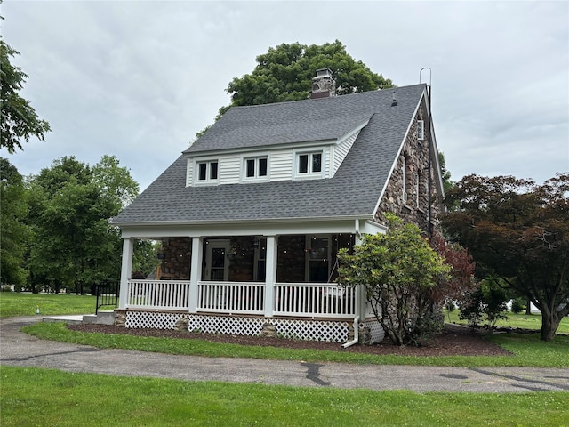 147 Lime Ridge Rd, Poughquag, NY 12570 - view of front facade featuring covered porch, a shingled roof, stone siding, a chimney, and a front lawn