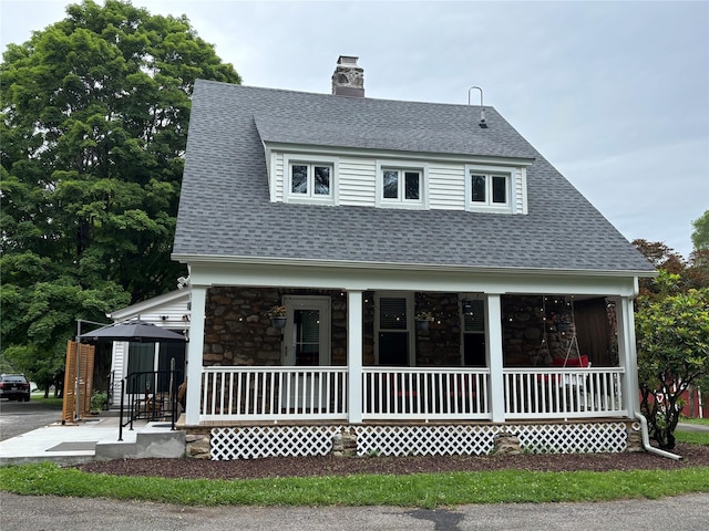 147 Lime Ridge Rd, Poughquag, NY 12570 - view of front of property featuring covered porch, stone siding, a shingled roof, and a chimney