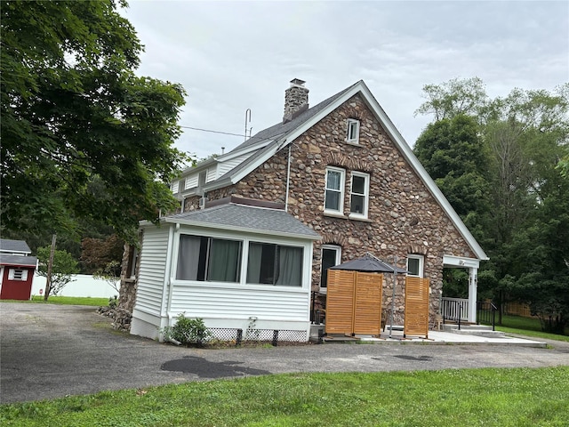 147 Lime Ridge Rd, Poughquag, NY 12570 - back of property featuring stone siding, a chimney, and roof with shingles