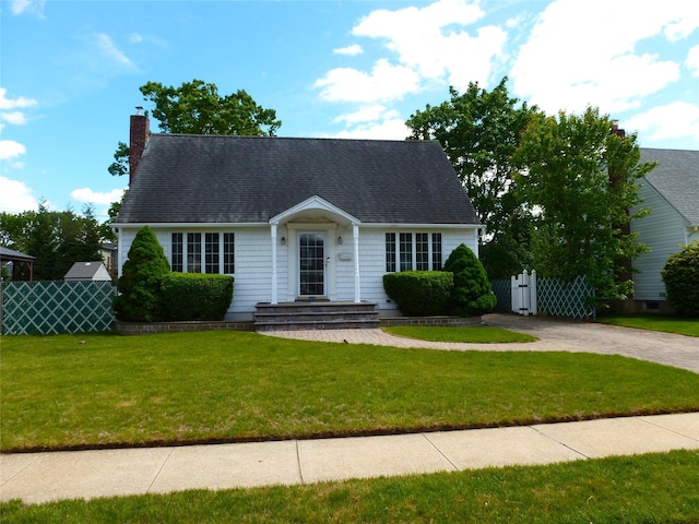 4010 Heywood Rd, Seaford, NY 11783 - new england style home featuring a chimney, a shingled roof, and driveway