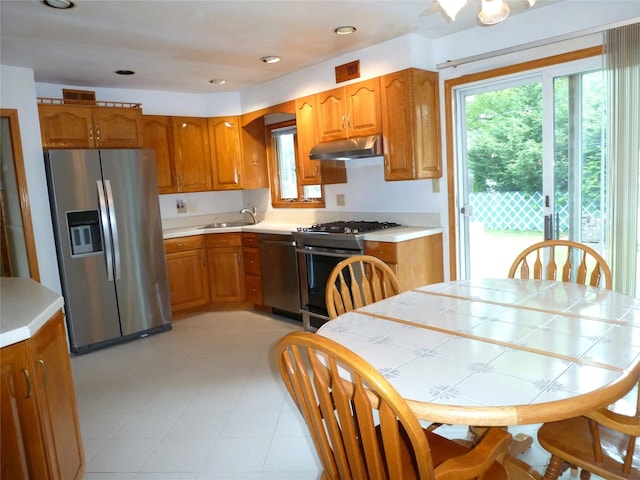 4010 Heywood Rd, Seaford, NY 11783 - kitchen featuring stainless steel fridge with ice dispenser, gas stove, dishwasher, under cabinet range hood, and a sink