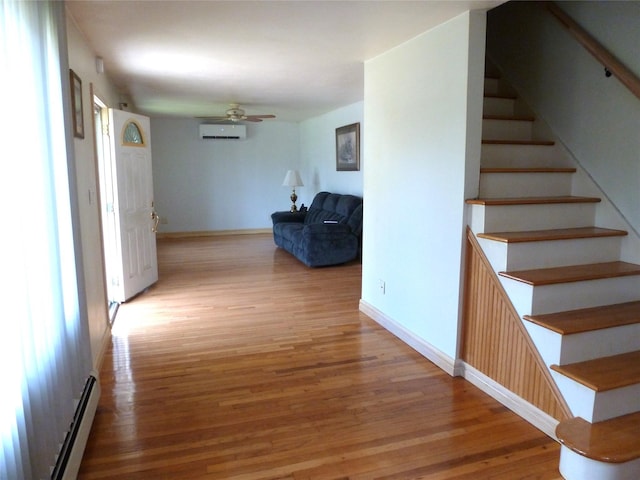 4010 Heywood Rd, Seaford, NY 11783 - hallway with an AC wall unit, light wood-type flooring, stairway, and baseboards