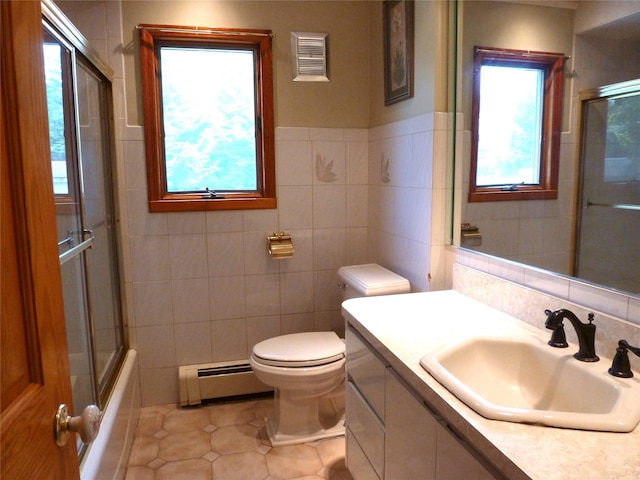 4010 Heywood Rd, Seaford, NY 11783 - full bath with baseboard heating, tile walls, tile patterned flooring, vanity, and toilet