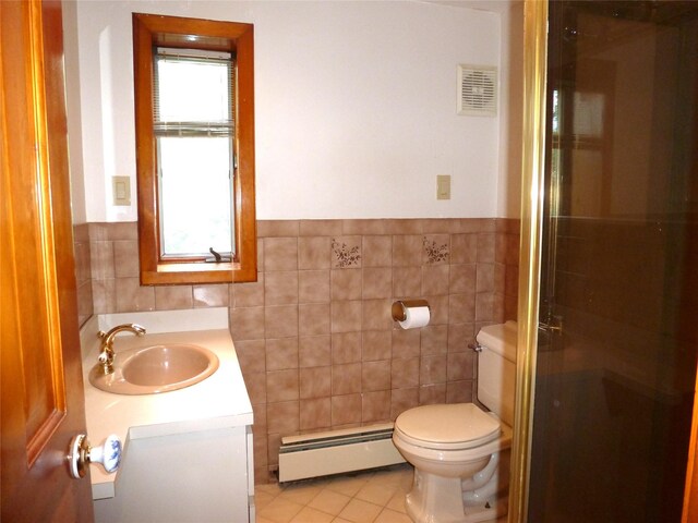 4010 Heywood Rd, Seaford, NY 11783 - full bathroom featuring a baseboard radiator, tile walls, vanity, toilet, and a stall shower