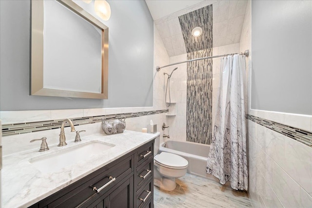 7 Kent Ct, Bayport, NY 11705 - bathroom featuring tile walls, vanity, toilet, shower / tub combo with curtain, and wainscoting