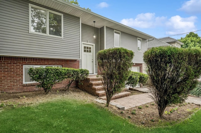 23 Tower St, Huntington Station, NY 11746 - entrance to property featuring brick siding and a lawn