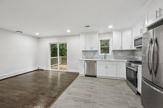 23 Tower St, Huntington Station, NY 11746 - kitchen with appliances with stainless steel finishes, a sink, plenty of natural light, recessed lighting, and backsplash