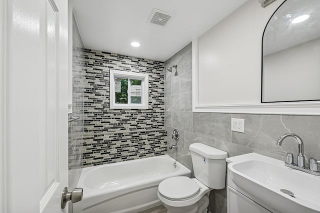 23 Tower St, Huntington Station, NY 11746 - bathroom featuring tub / shower combination, vanity, tile walls, backsplash, and toilet
