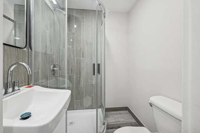23 Tower St, Huntington Station, NY 11746 - bathroom with a sink, toilet, a shower stall, and baseboards