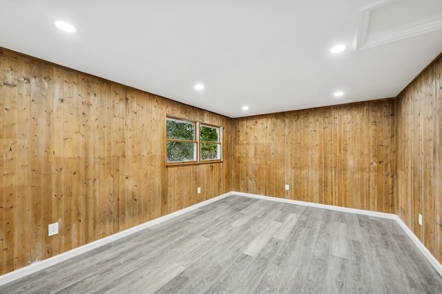 23 Tower St, Huntington Station, NY 11746 - empty room with wood finished floors, wooden walls, recessed lighting, and baseboards
