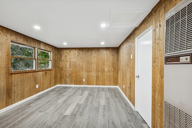 23 Tower St, Huntington Station, NY 11746 - spare room featuring a heating unit, wood finished floors, wooden walls, baseboards, and recessed lighting