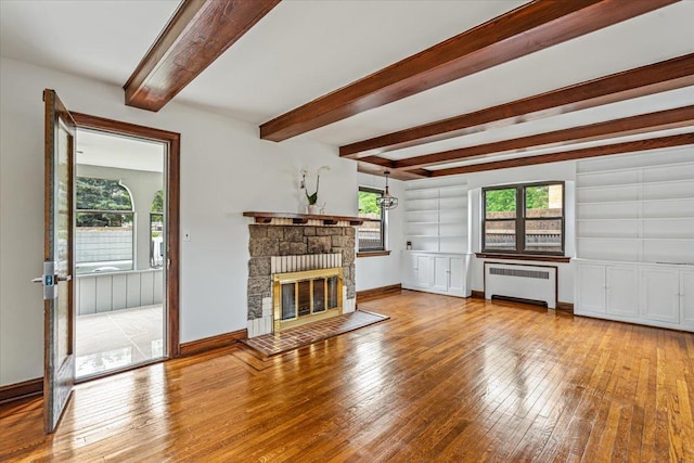 164-03 33rd Ave, Flushing, NY 11358 - unfurnished living room with radiator heating unit, hardwood / wood-style floors, healthy amount of natural light, and beamed ceiling