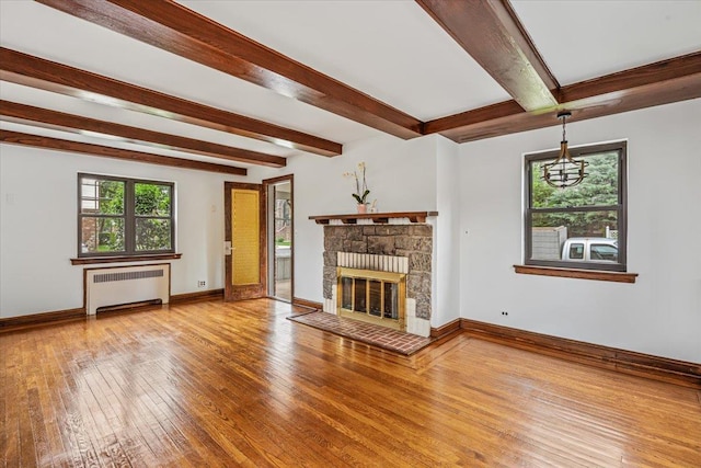 164-03 33rd Ave, Flushing, NY 11358 - unfurnished living room with radiator, beam ceiling, hardwood / wood-style flooring, a fireplace, and baseboards