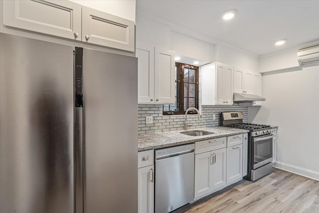 164-03 33rd Ave, Flushing, NY 11358 - kitchen featuring stainless steel appliances, a sink, under cabinet range hood, tasteful backsplash, and light wood-type flooring