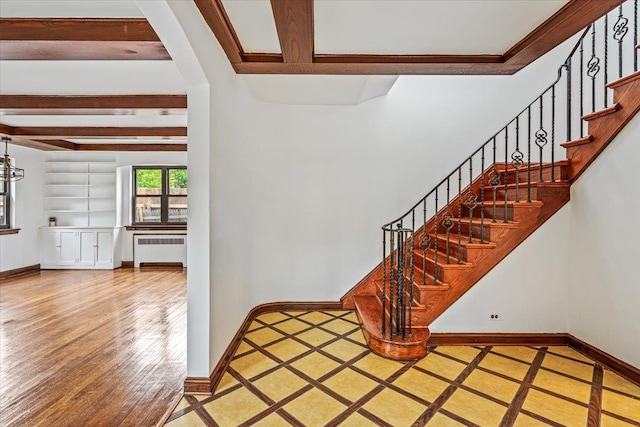 164-03 33rd Ave, Flushing, NY 11358 - stairway featuring radiator heating unit, beamed ceiling, baseboards, and wood-type flooring