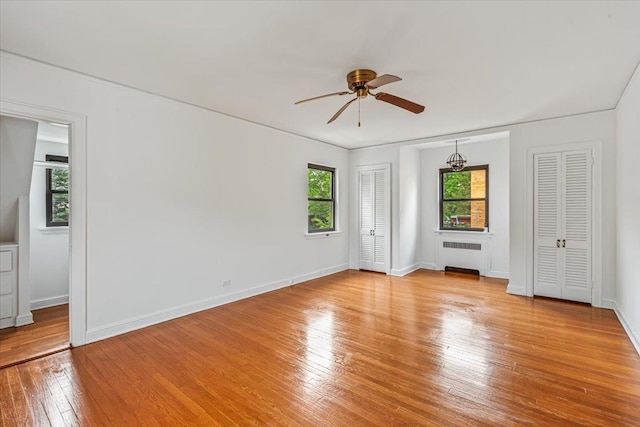 164-03 33rd Ave, Flushing, NY 11358 - unfurnished bedroom with radiator, light wood-type flooring, baseboards, and ceiling fan