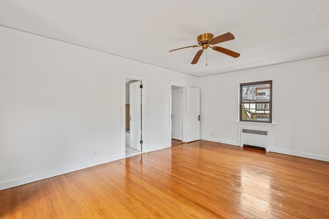 164-03 33rd Ave, Flushing, NY 11358 - unfurnished room featuring radiator, ceiling fan, light wood finished floors, and baseboards